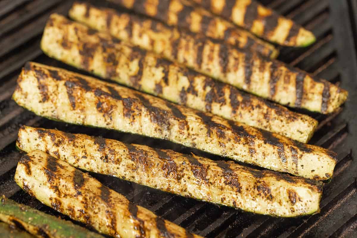 close up of grilled zucchini batons with grill marks.