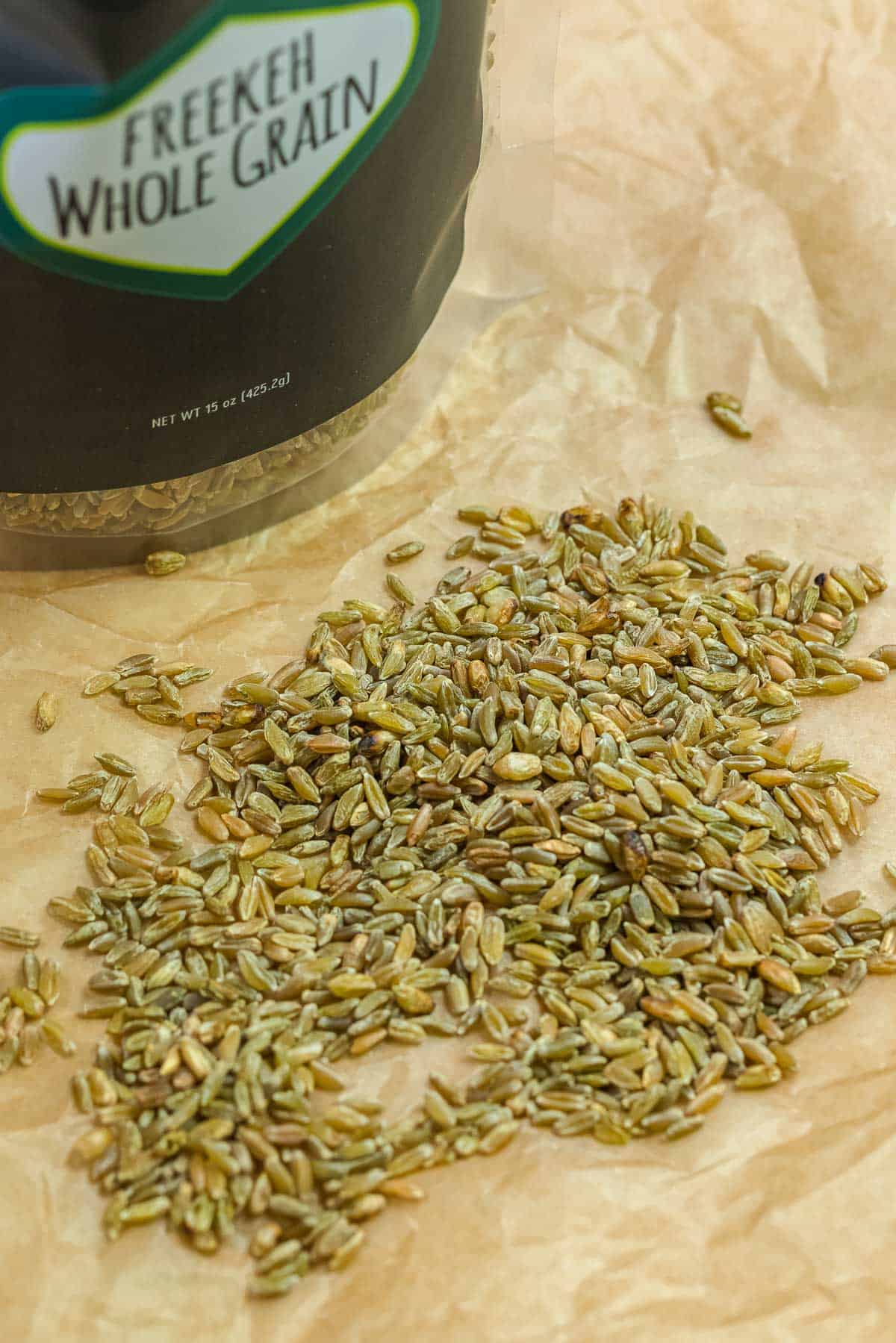 close up of freekeh grains with The Mediterranean Dish wholegrain freekeh in the background.