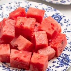 watermelon cubes on a blue and white plate.