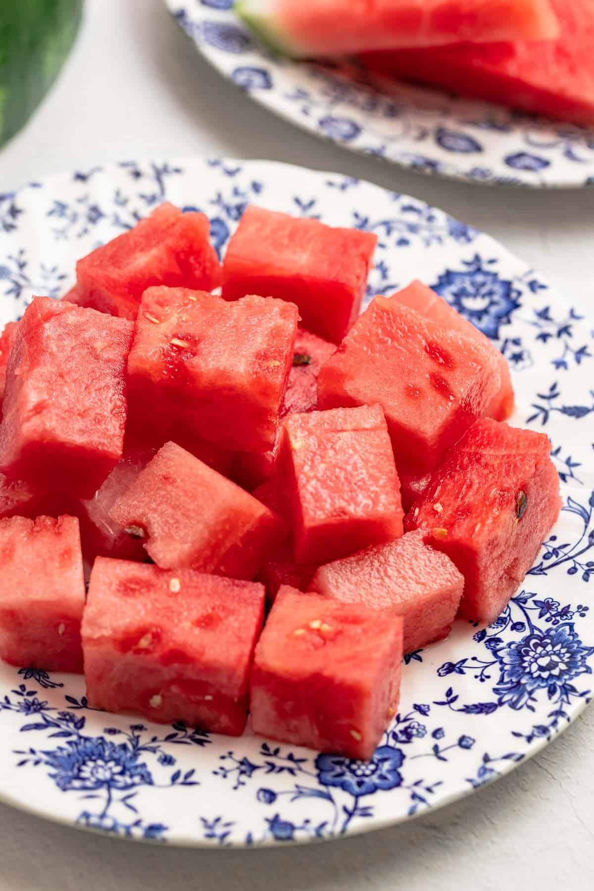 watermelon cubes on a blue and white plate.