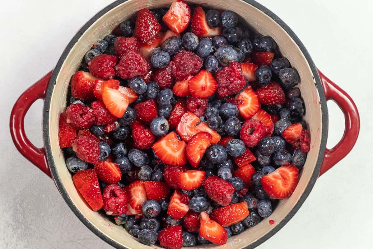 blueberries, raspberries, and strawberries in a large pot.
