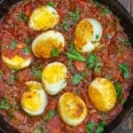 eggs in spicy tomato sauce with a garnish of fresh parsley