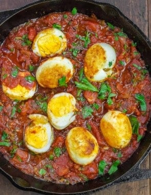 eggs in spicy tomato sauce with a garnish of fresh parsley