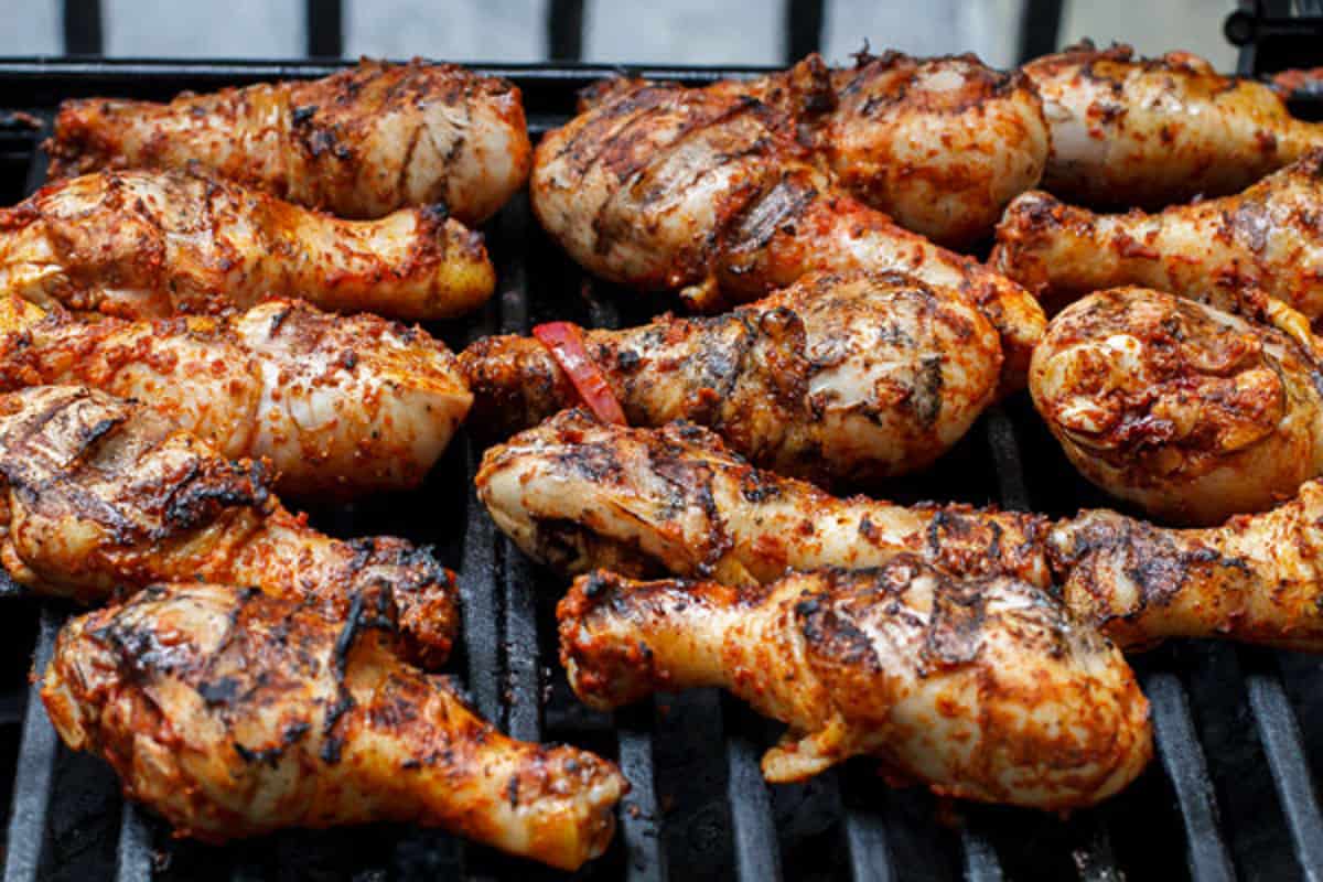 chicken legs cooking on the grill.