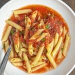 penne and no cook tomato sauce in a white bowl.