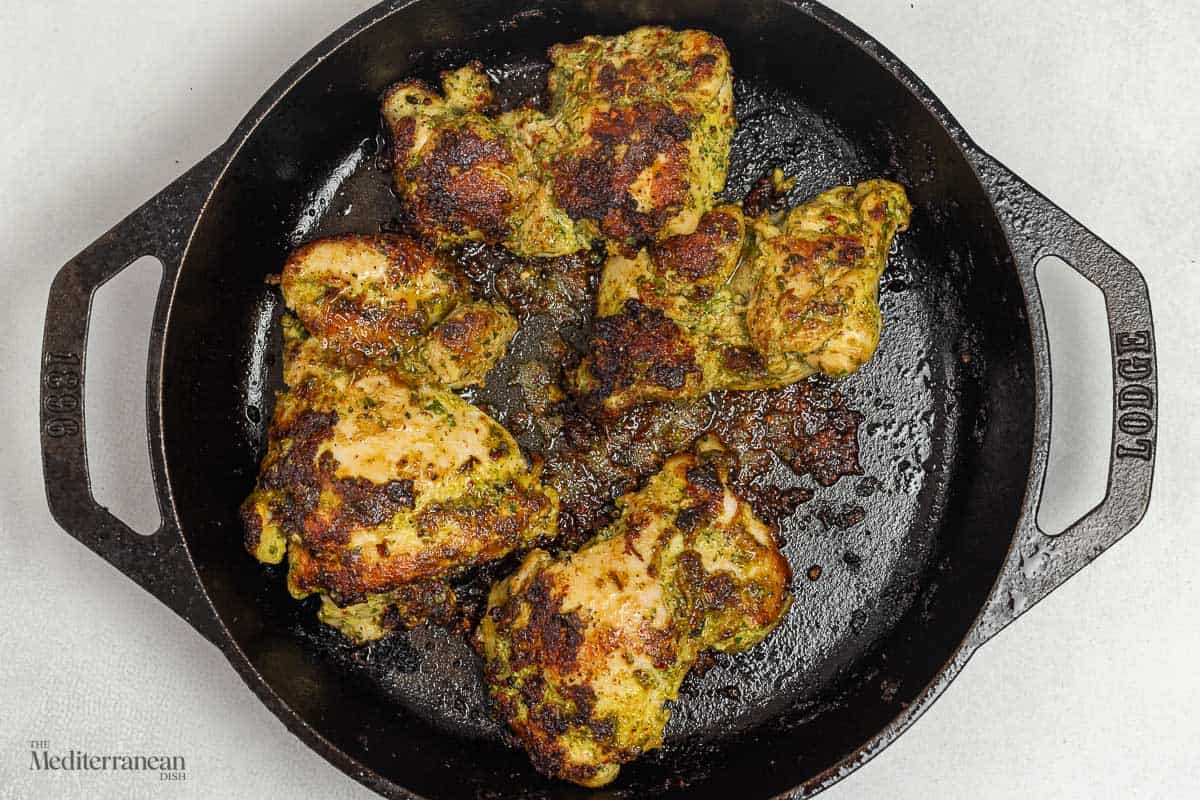 green goddess chicken cooking in a skillet.