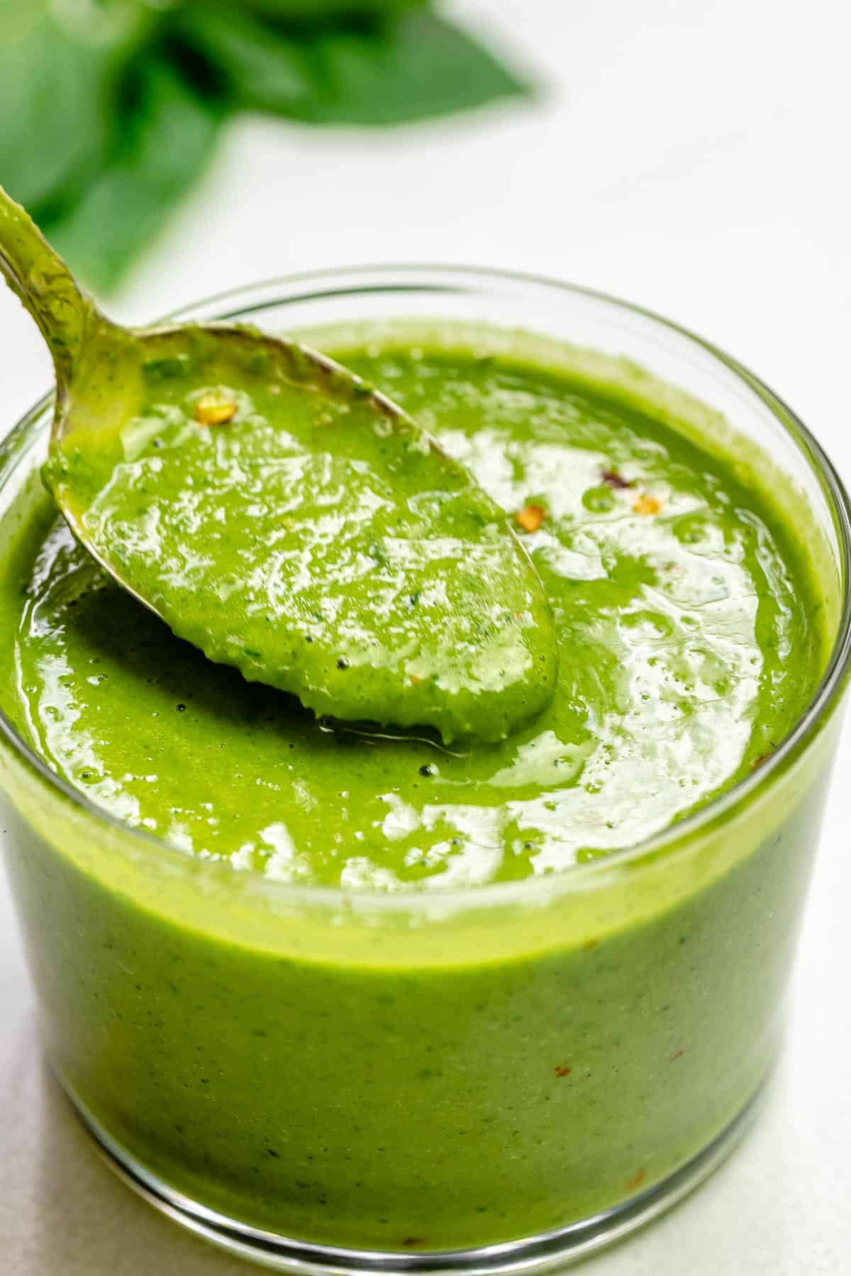 basil salad dressing in a small glass jar.