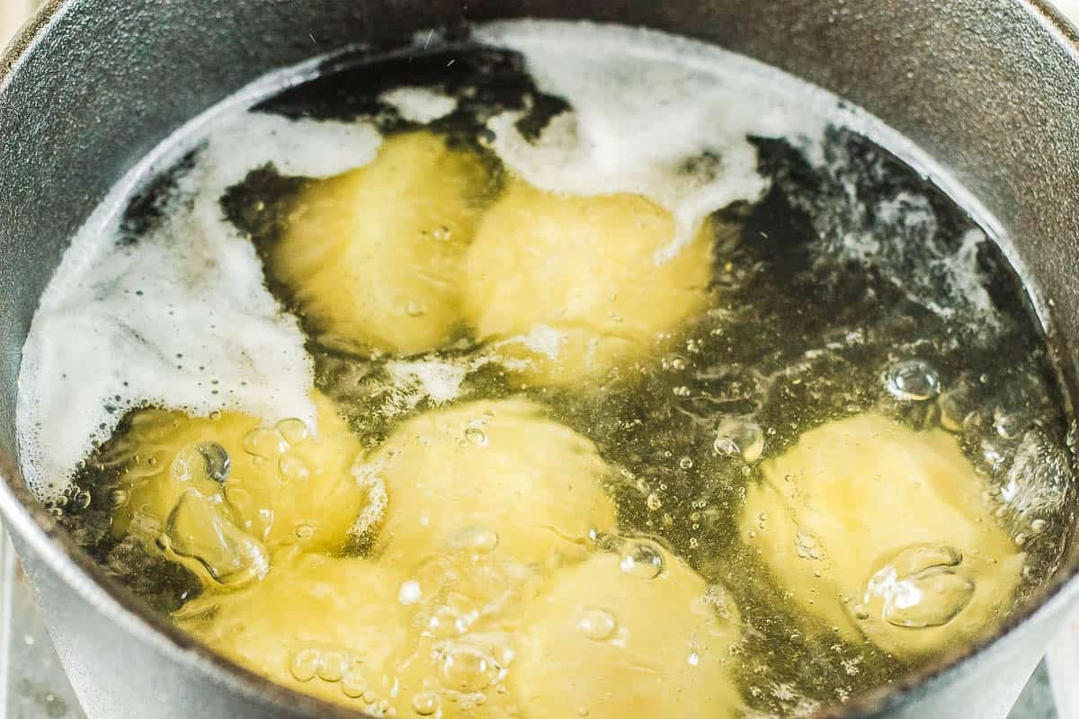 whole Yukon gold potatoes in boiling water.