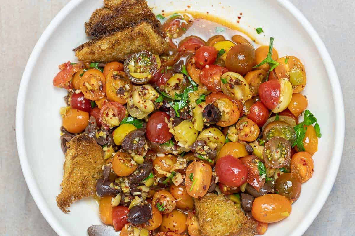 cherry tomato salad with olives and garlic with fried sourdough bread.