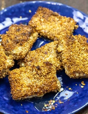 pan-fried feta cheese on a blue plate.