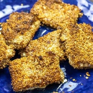 pan-fried feta cheese on a blue plate.