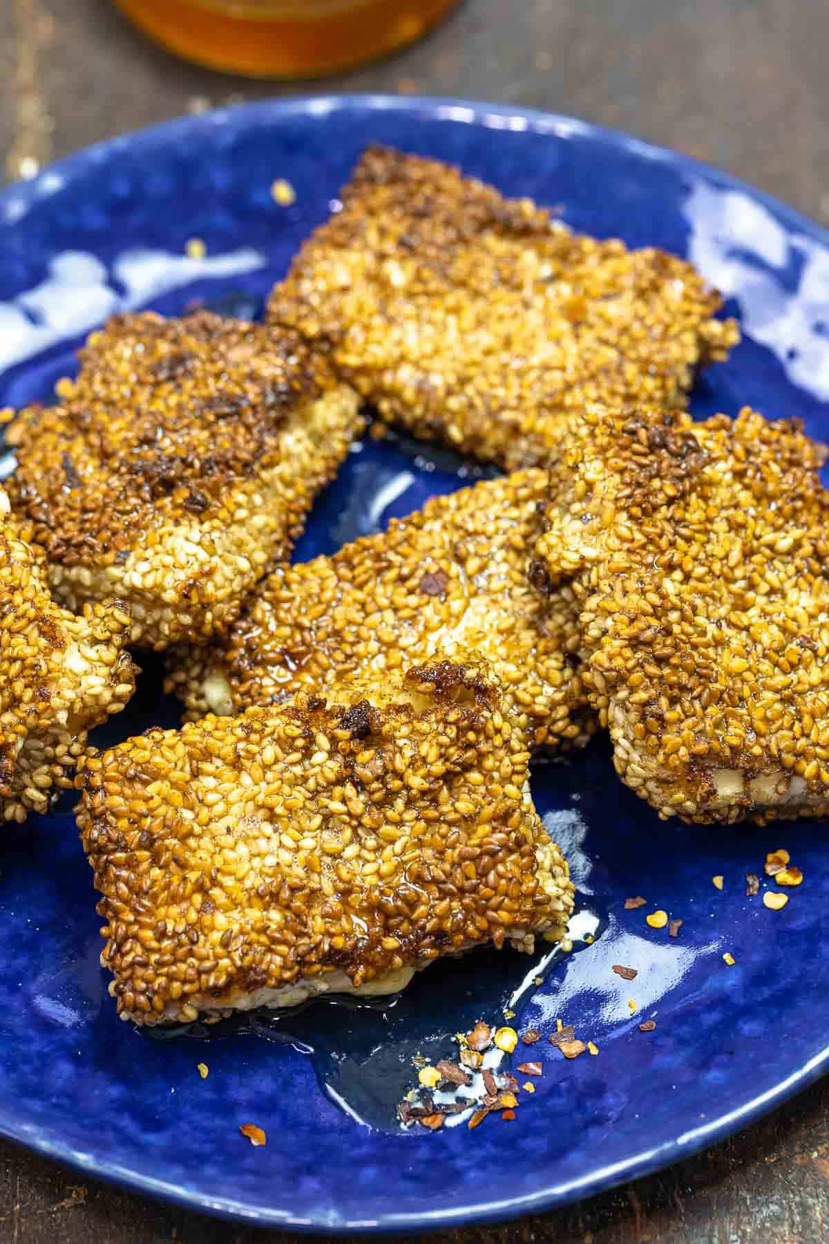 pan-fried feta cheese on a blue plate.