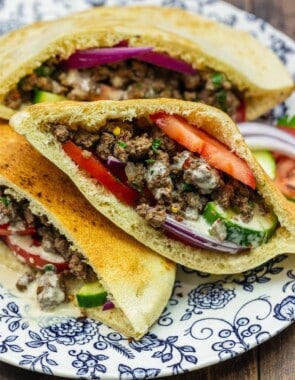 Middle Eastern sandwich in a pita on a blue and white plate.