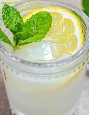 ouzo drink with fresh lemon, ice, and mint leaves.