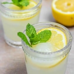 ouzo drink (similar to ouzo lemonade) with lemon slices and fresh mint.