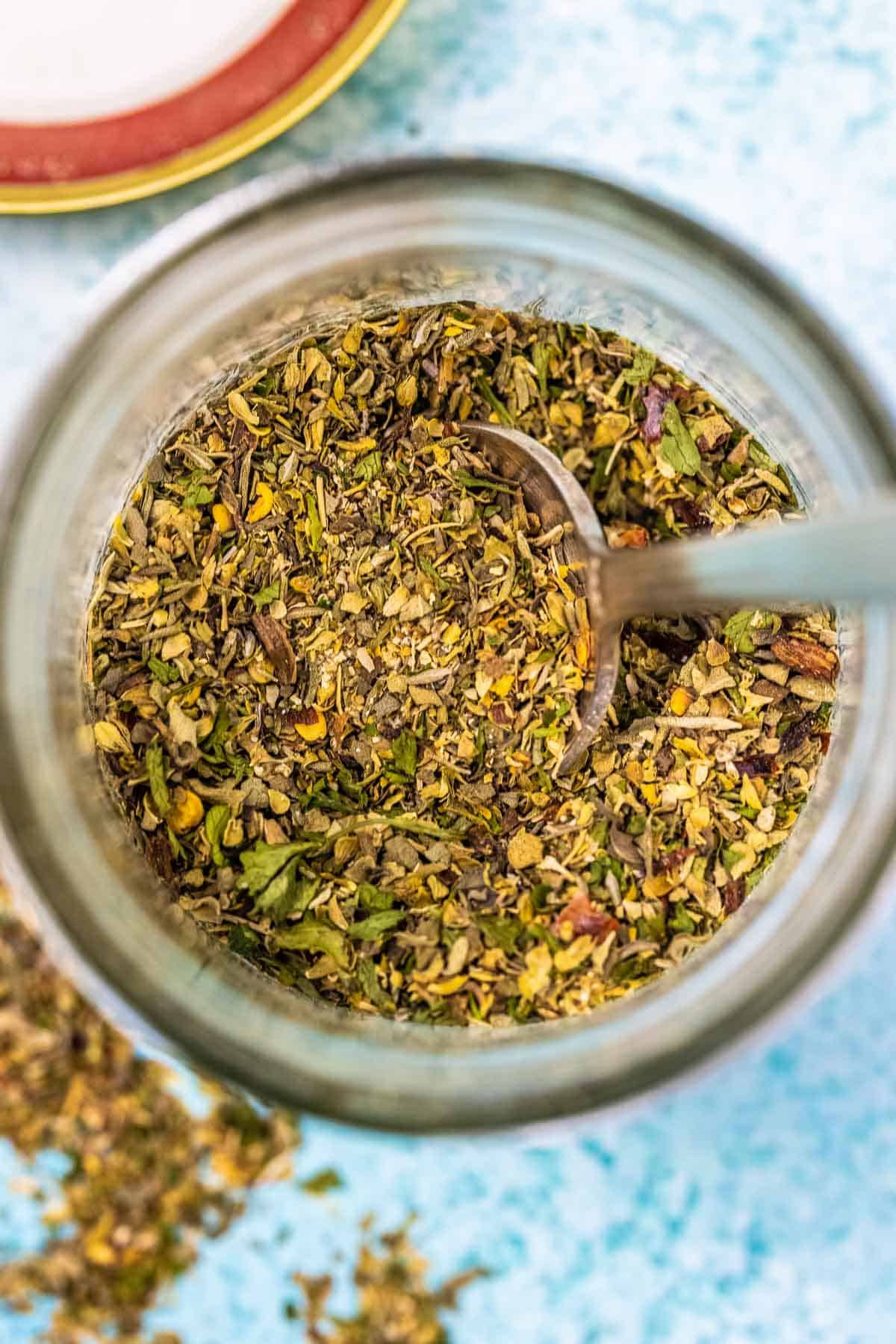 Homemade Italian seasoning in a glass jar.