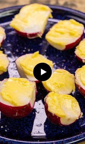Radishes with butter on a tray.
