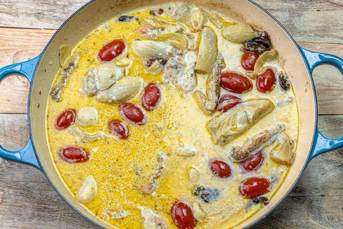chicken, cherry tomatoes, and artichokes in a milk-based pasta sauce.