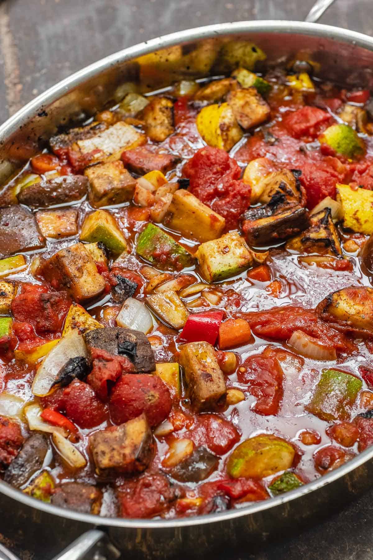 saucy roasted vegetables in a baking dish.