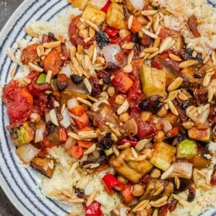 roasted vegetables on a bed of couscous served on a plate.