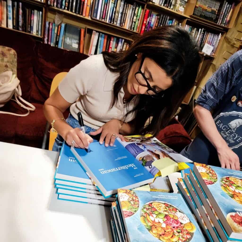 Suzy Karadsheh signing cookbooks