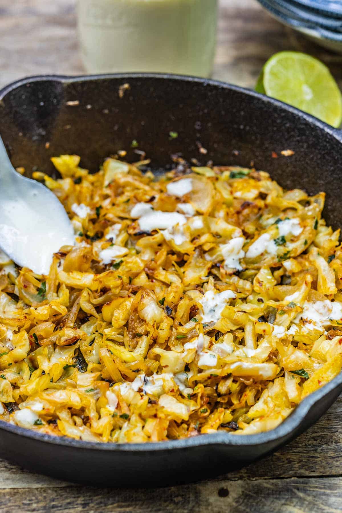 sautéed cabbage with feta dressing drizzled on top.