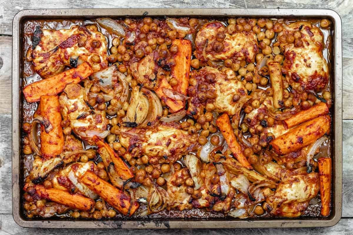 sheet pan chicken with chickpeas and carrots after coming out of the oven.