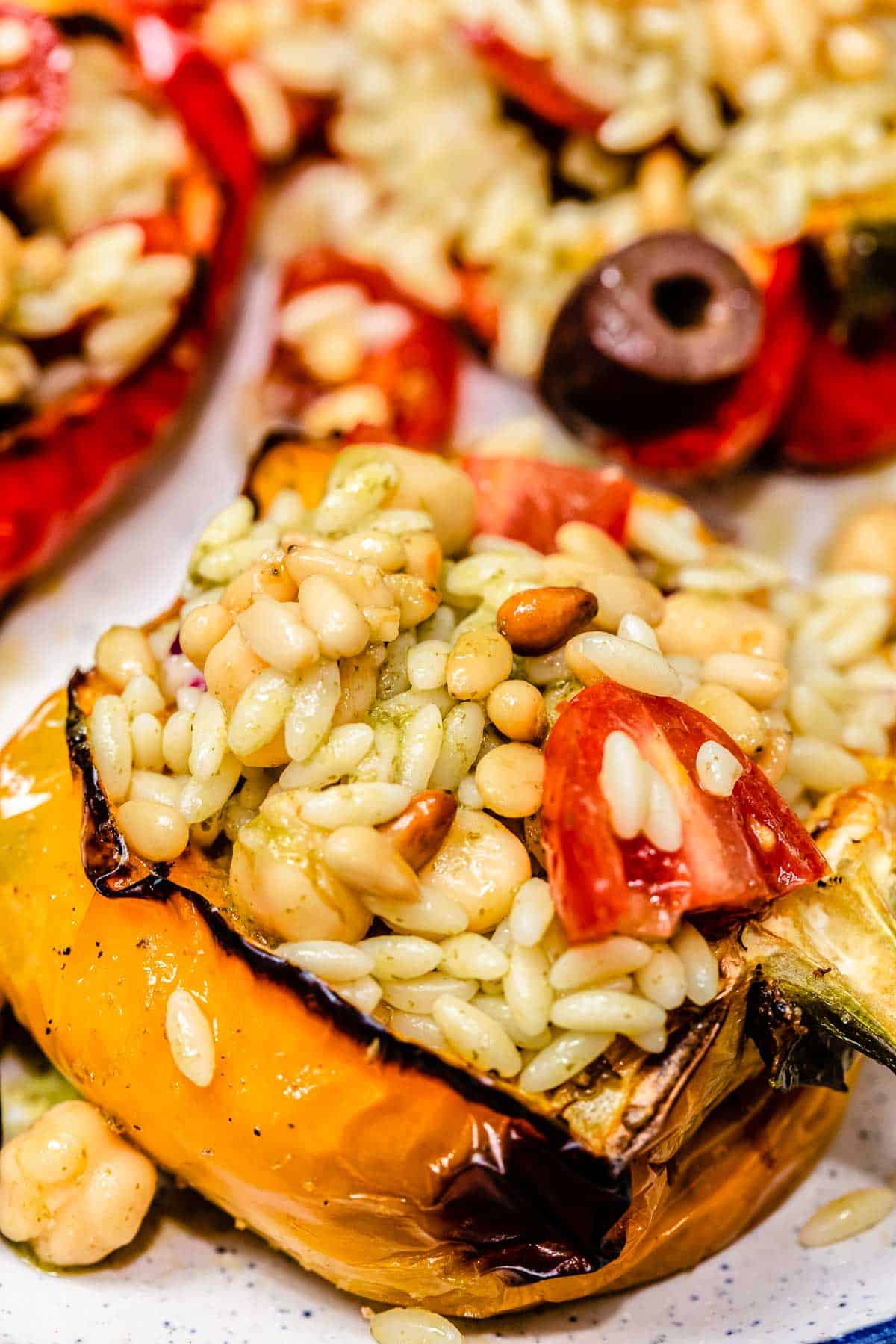 close up of stuffed bell pepper with orzo and chickpea filling.