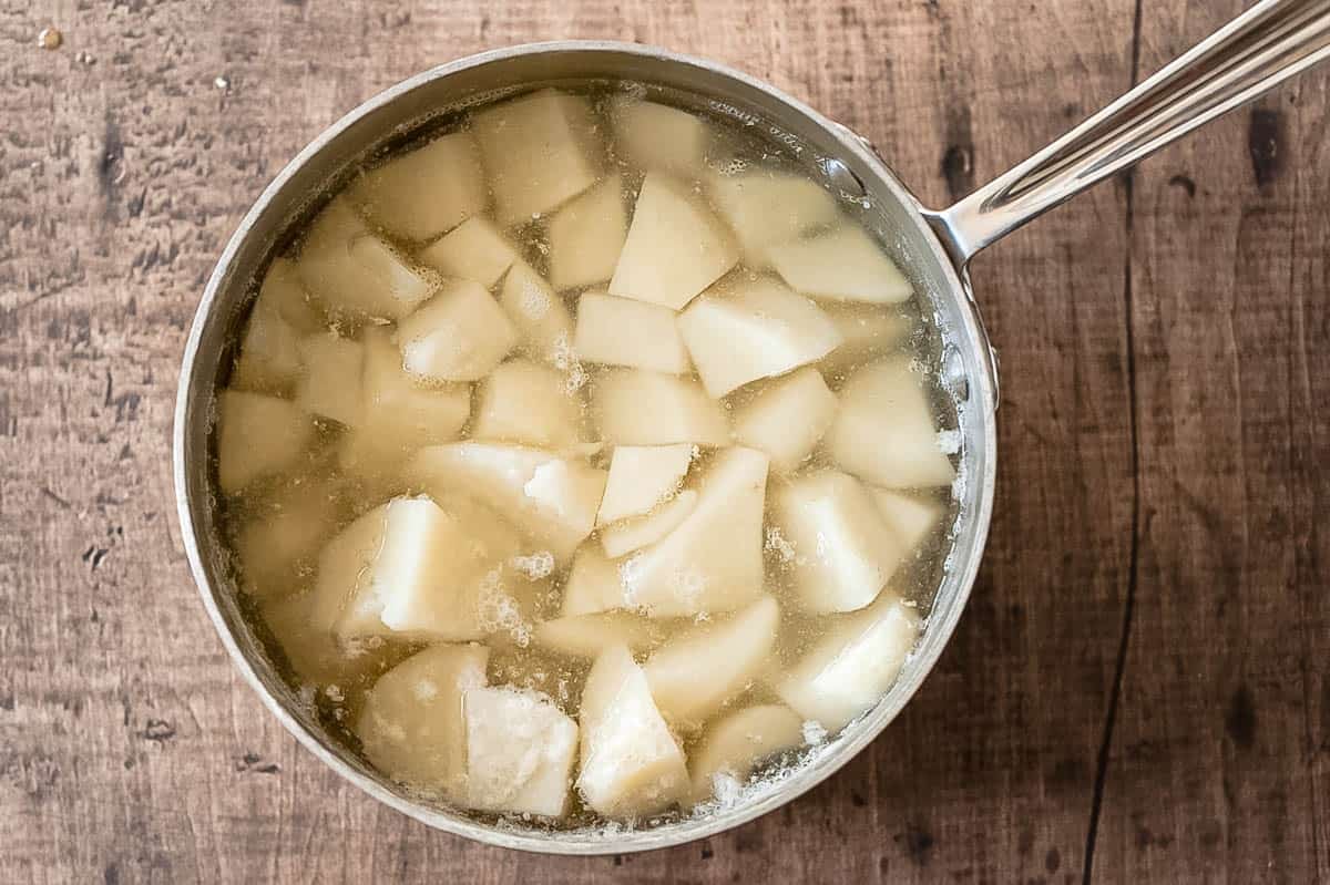 Cubed potatoes boiling in a pot of water