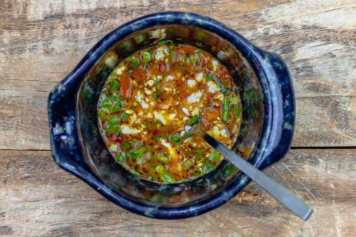 egg, vegetable, and herb mixture in a bowl.