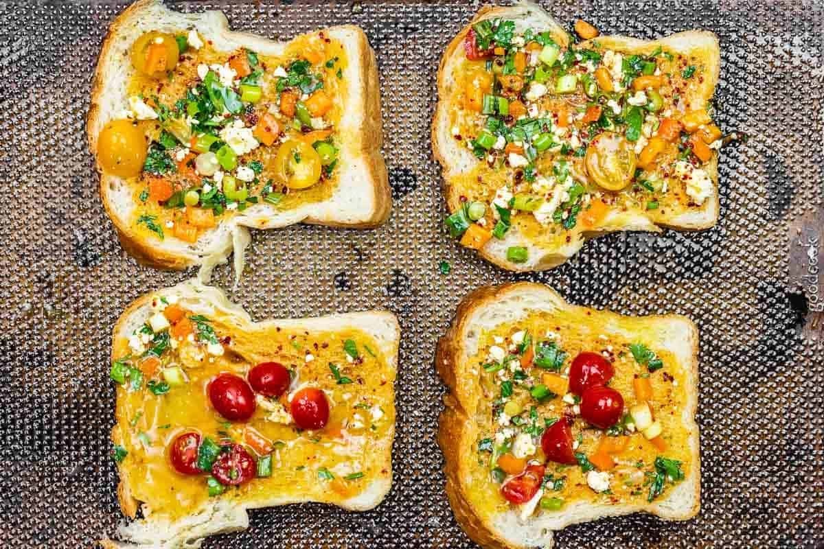 bread with egg and vegetable mixture spooned on top.
