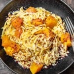 pasta with butternut puree and chunks of butternut in a bowl.