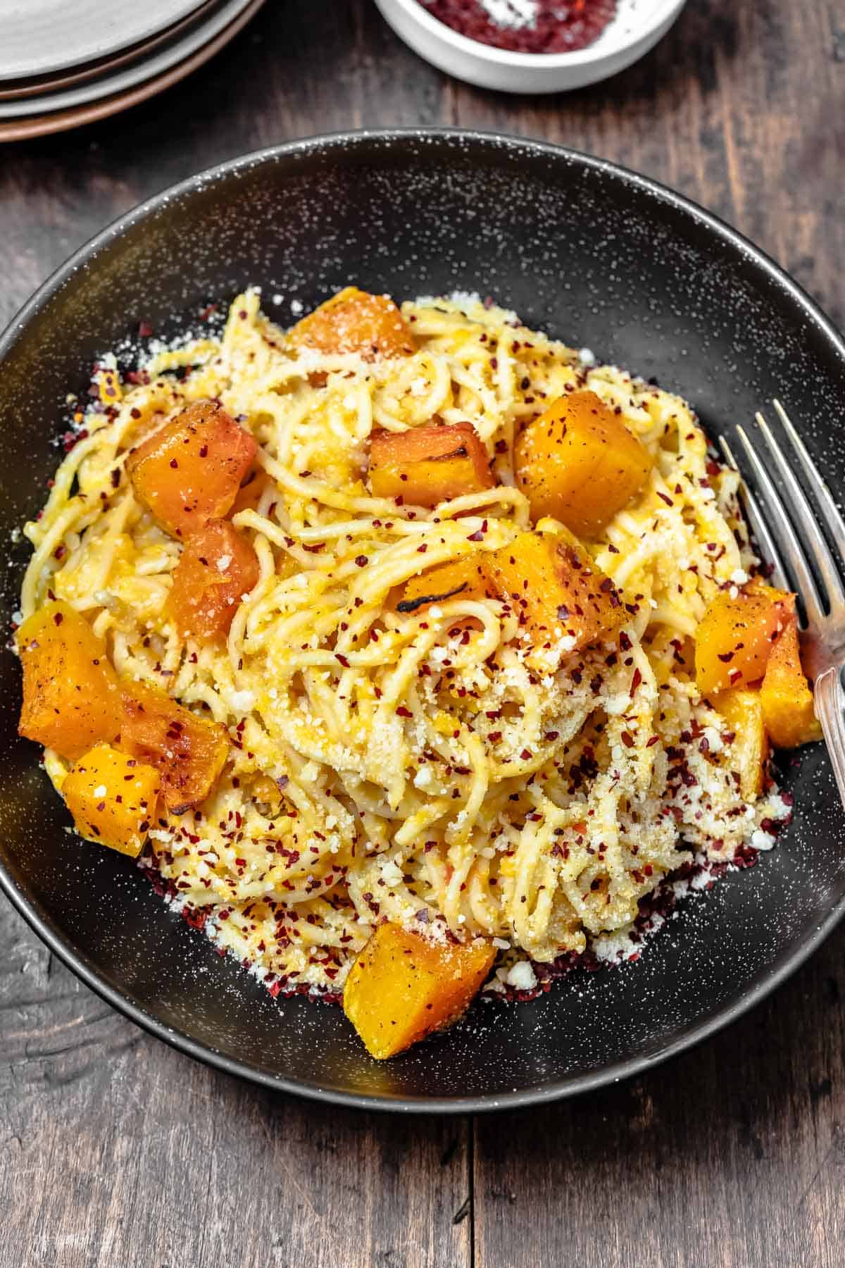 pasta with butternut puree and chunks of butternut in a bowl.