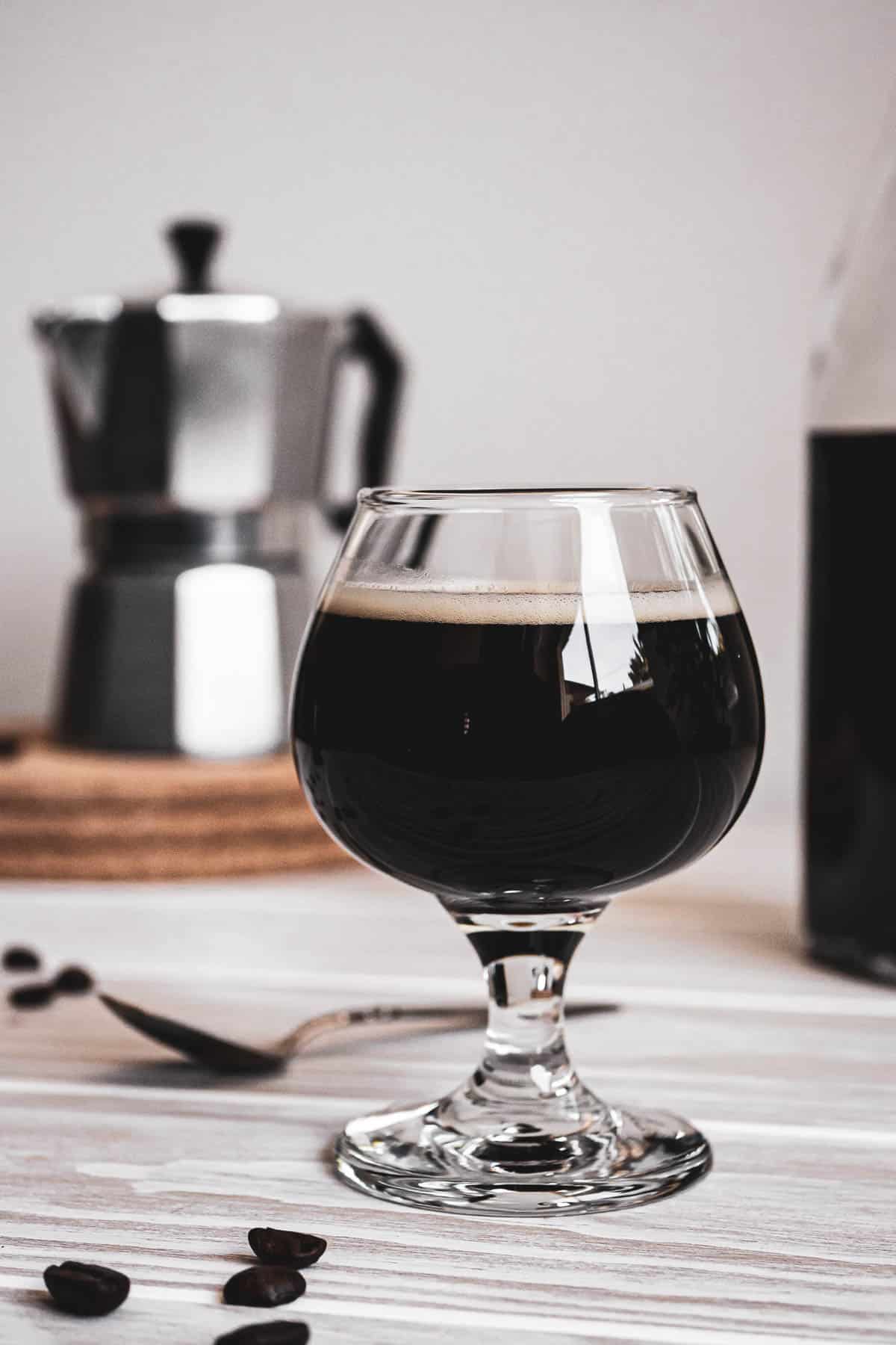 Coffee cocktail in a glass goblet.