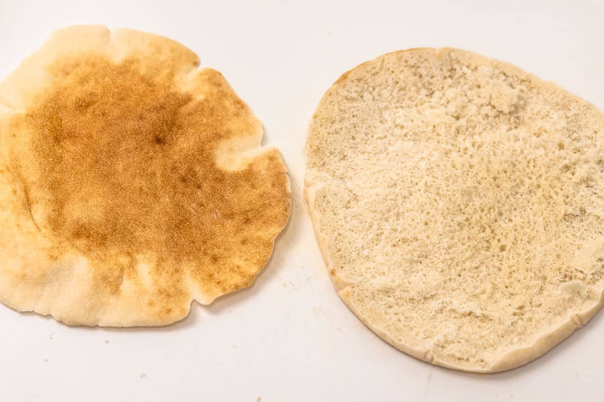 pita bread sliced in half to create two flat rounds.