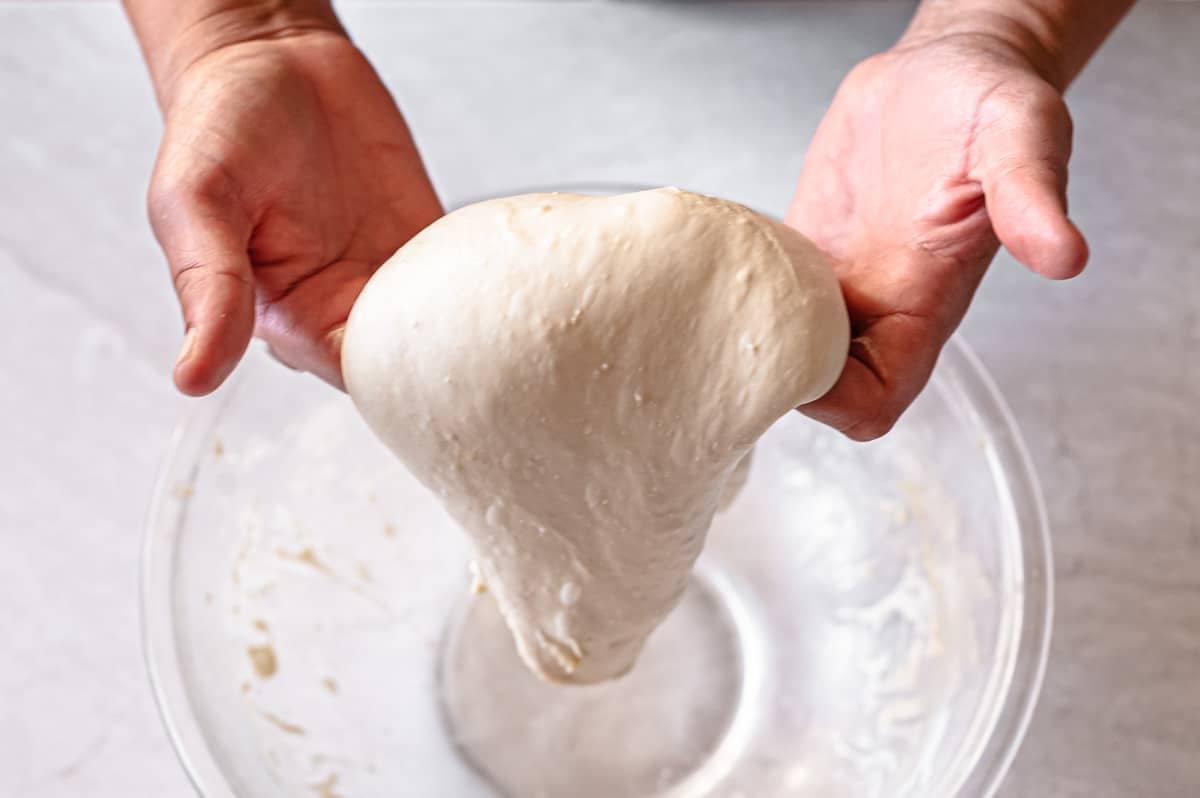 stretching focaccia dough.