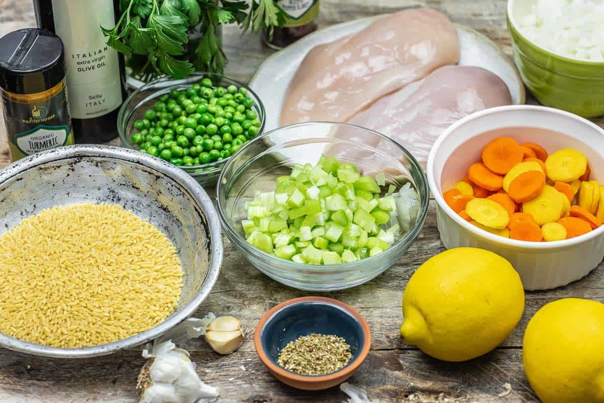 Ingredient photo for Lemon Orzo Chicken soup with orzo, peas, celery, carrots, lemons, Italian seasoning, olive oil, turmeric, onions, parsley, chicken breasts and garlic.