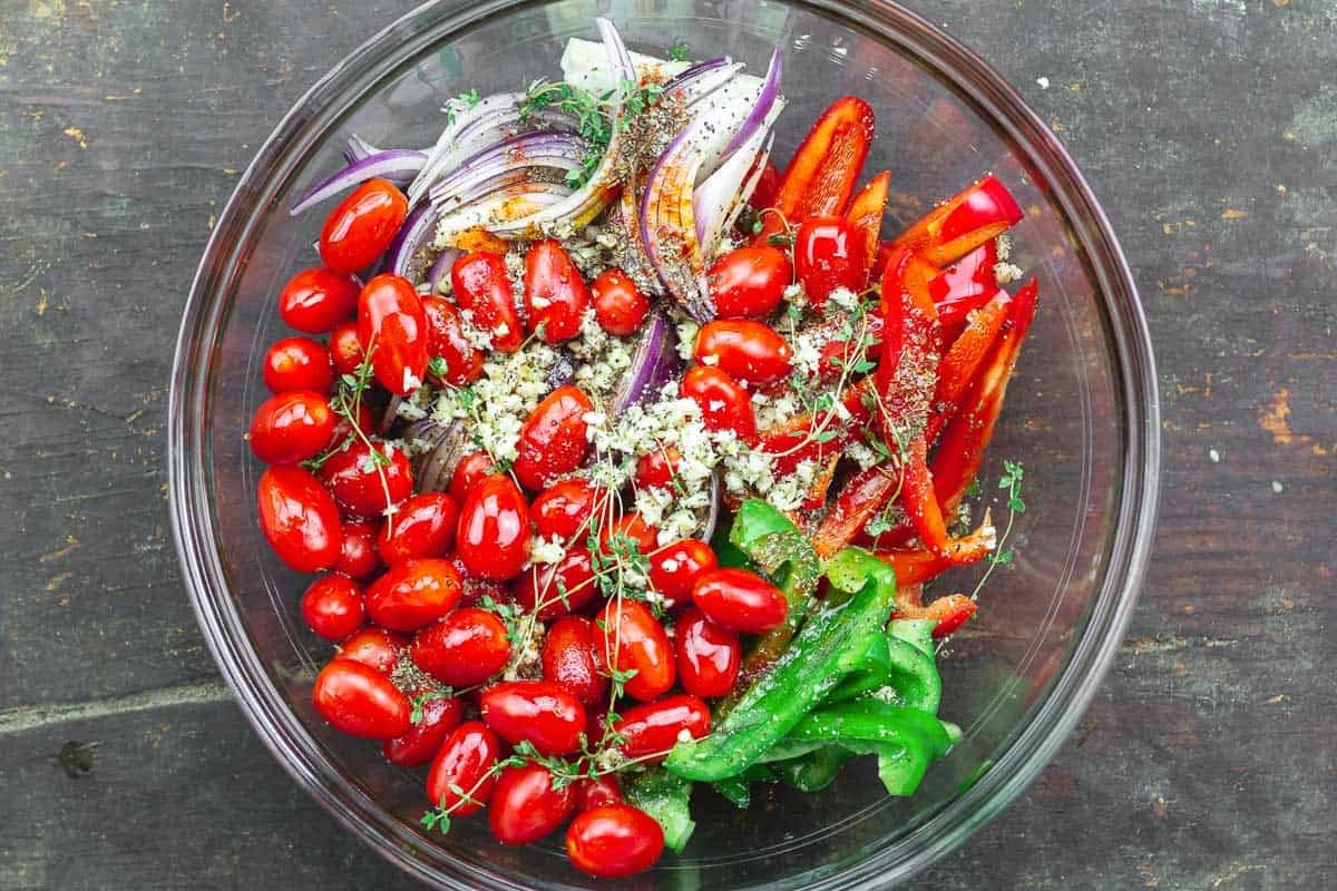 vegetables in a bowl with seasoning on top.