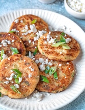 A white plate with multiple potato pancakes.