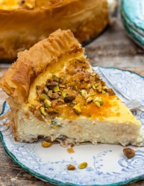 a slice of baklava cheesecake on a plate with a fork.