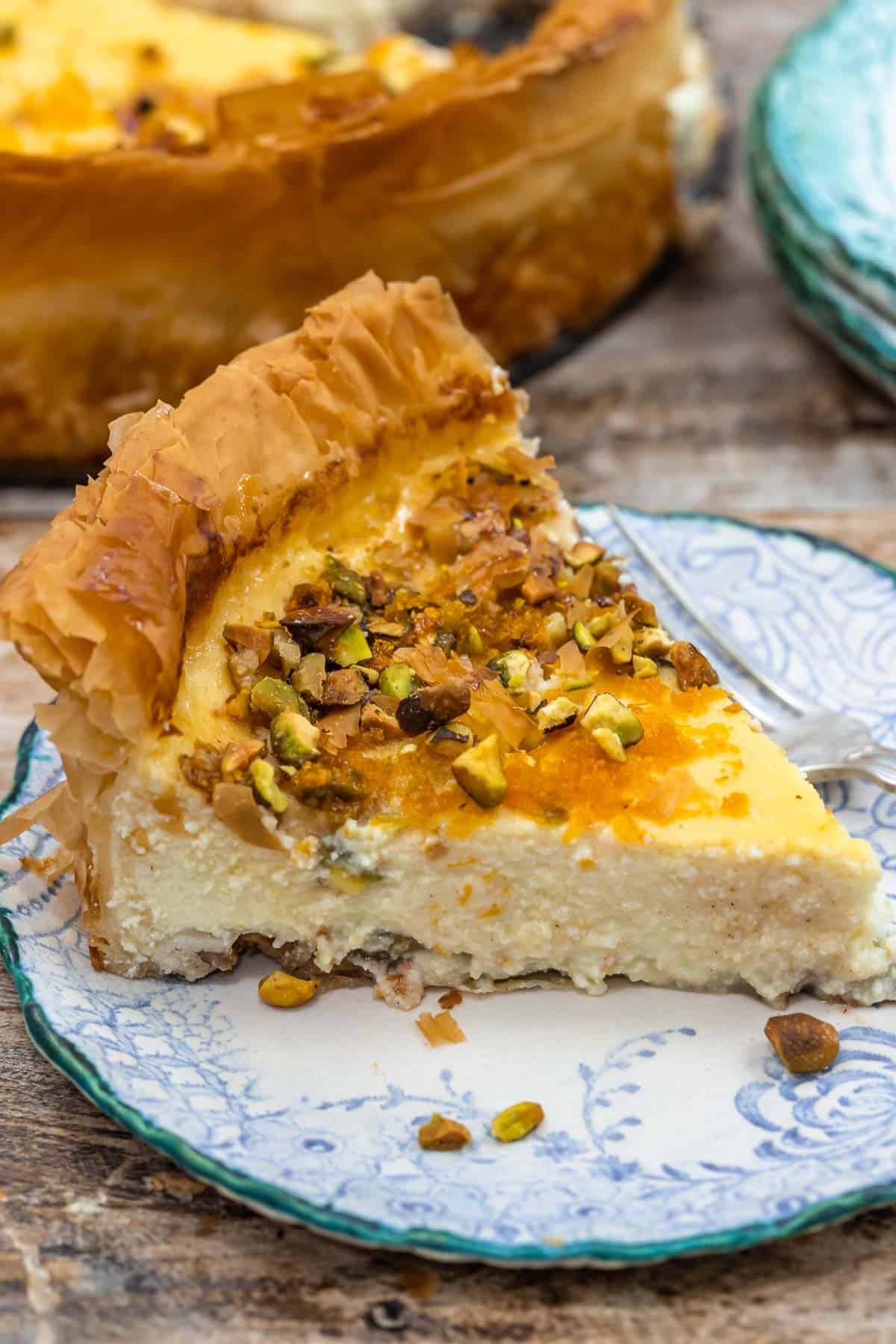 a slice of baklava cheesecake on a plate with a fork.