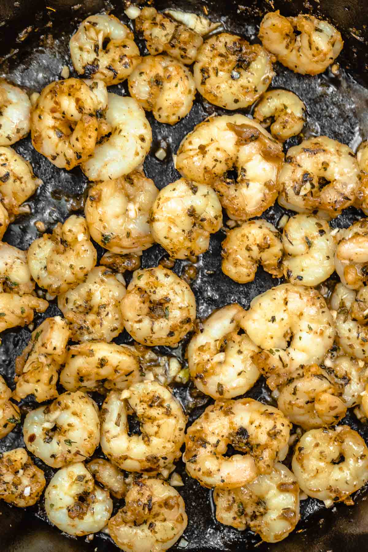 close up of shrimp sautéing in a skillet.