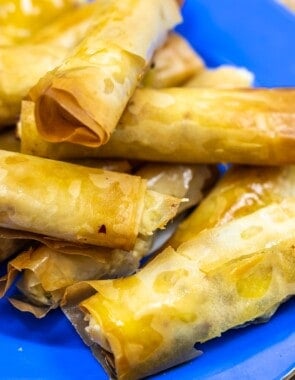 close up of sigara boregi rolls on a blue plate.