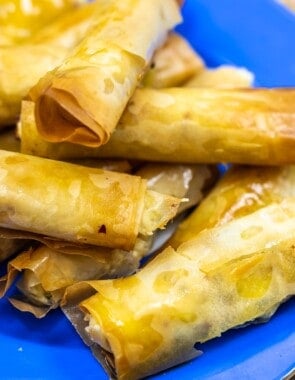 close up of sigara boregi rolls on a blue plate.