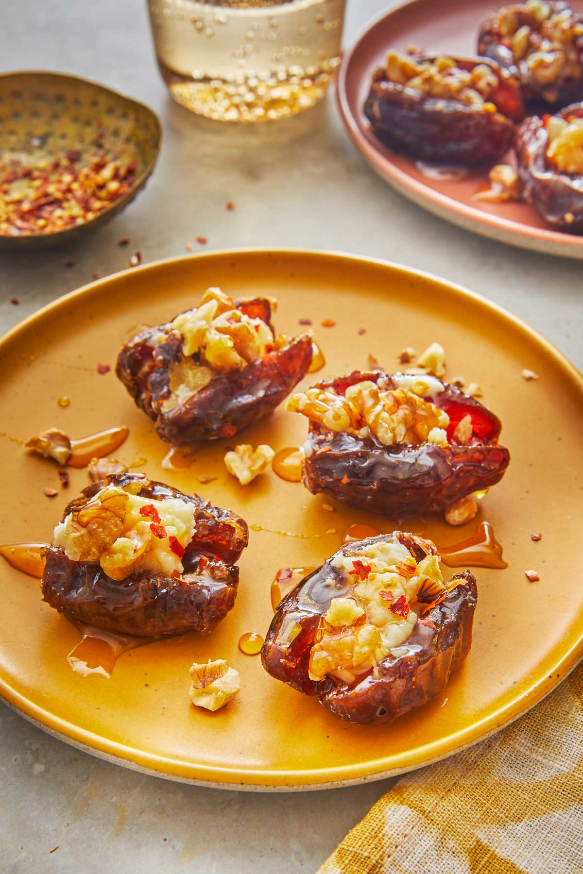 four cheese stuffed dates on a plate.