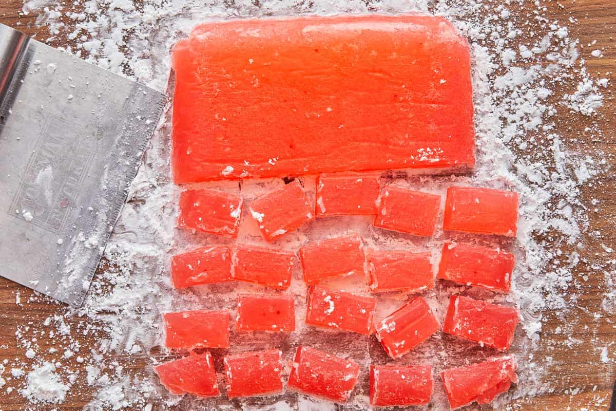 large block of turkish delight being cut into smaller pieces.
