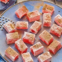 close up of pieces of turkish delight on a serving plate.