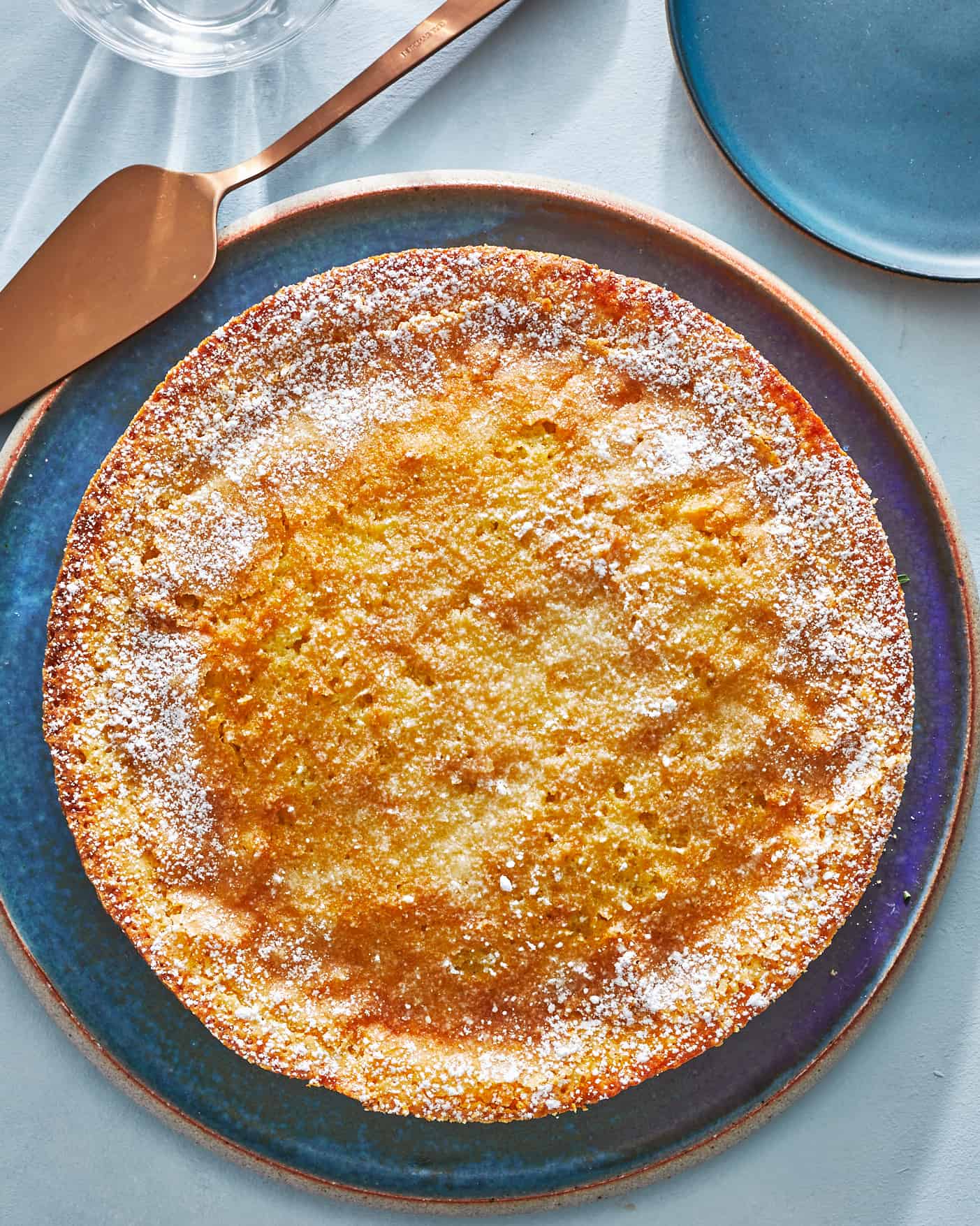 an entire orange cardamom olive oil cake on a plate.