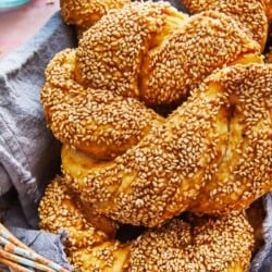 a close up of a baked simit dough ring in a basket.