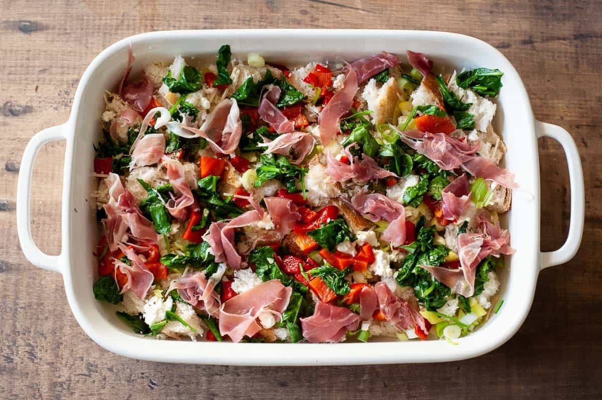 Uncooked breakfast strata in a baking dish.